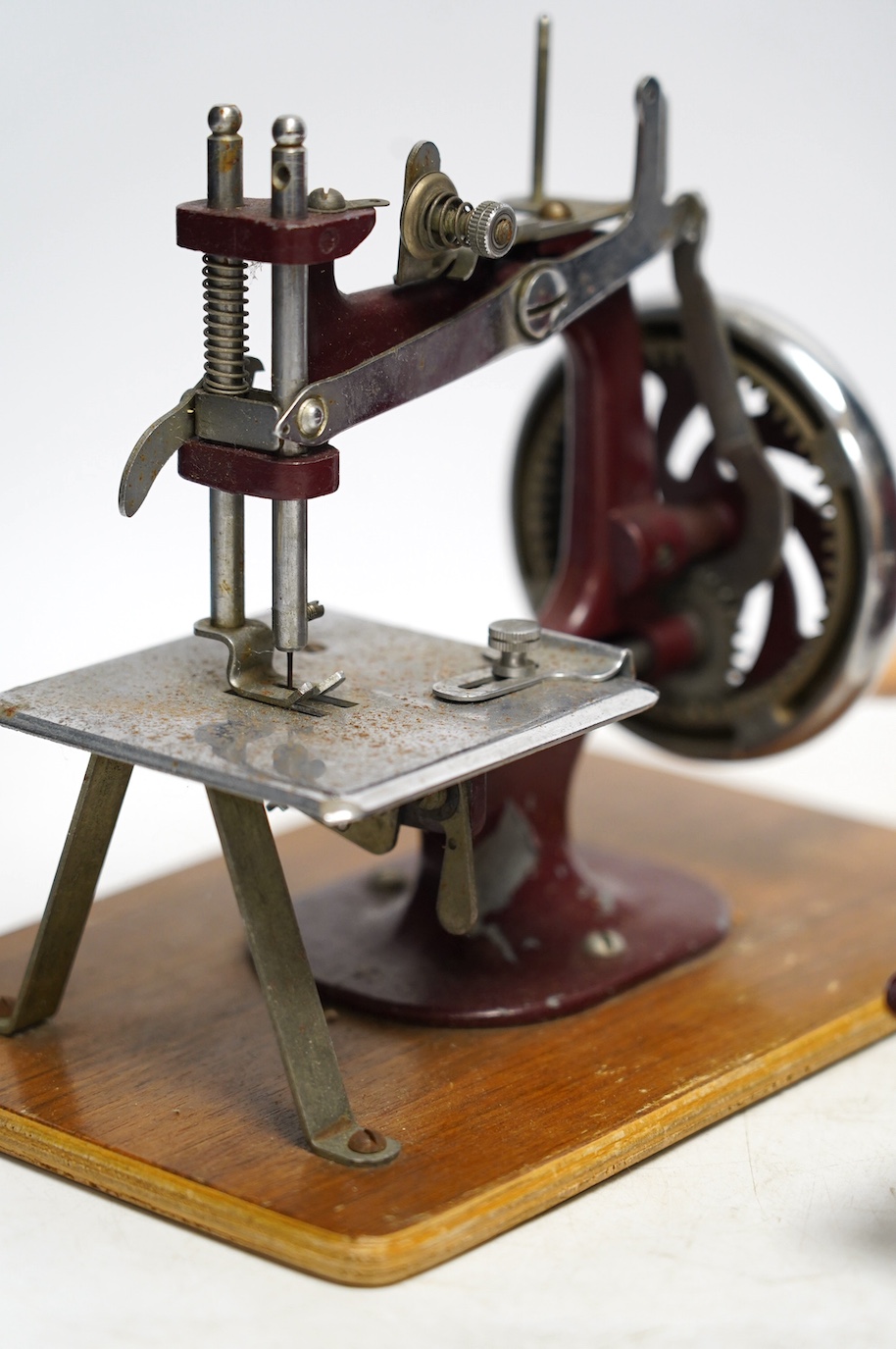 Two mid 20th century child’s sewing machines including a Vulcan Senior sewing machine in metallic red finish. Condition - fair